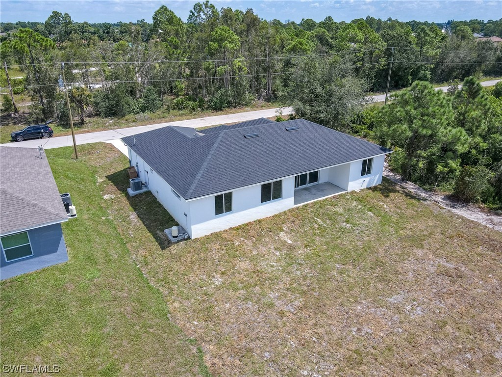 3233 Ruth Lane Lehigh Acres, FL 33976 - Photo 18 of 23 an aerial view of a house with a yard