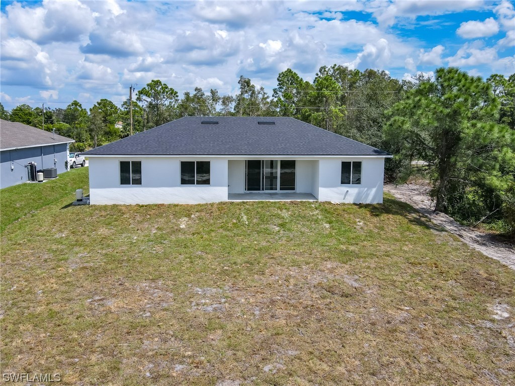3233 Ruth Lane Lehigh Acres, FL 33976 - Photo 19 of 23 front view of house with a yard