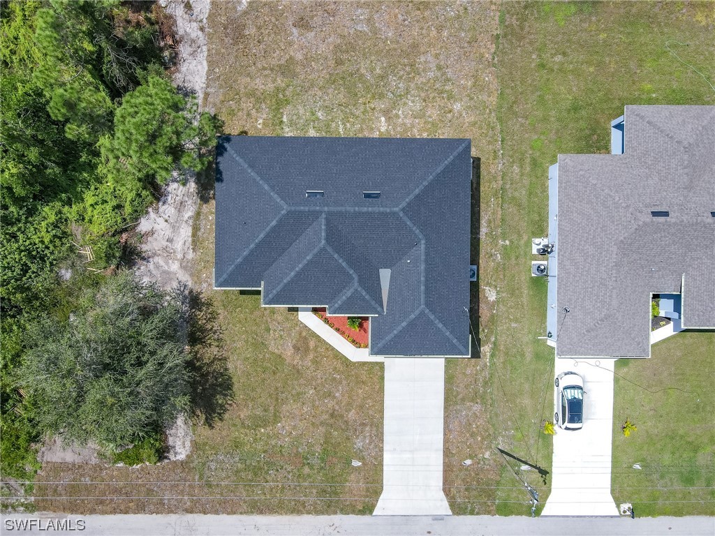 3233 Ruth Lane Lehigh Acres, FL 33976 - Photo 20 of 23 an aerial view of a house with a yard basket ball court and outdoor seating