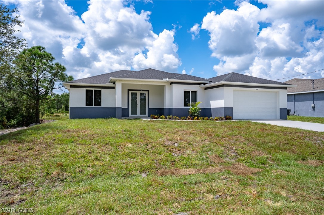 3233 Ruth Lane Lehigh Acres, FL 33976 - Photo 23 of 23 a front view of house with yard and trees around