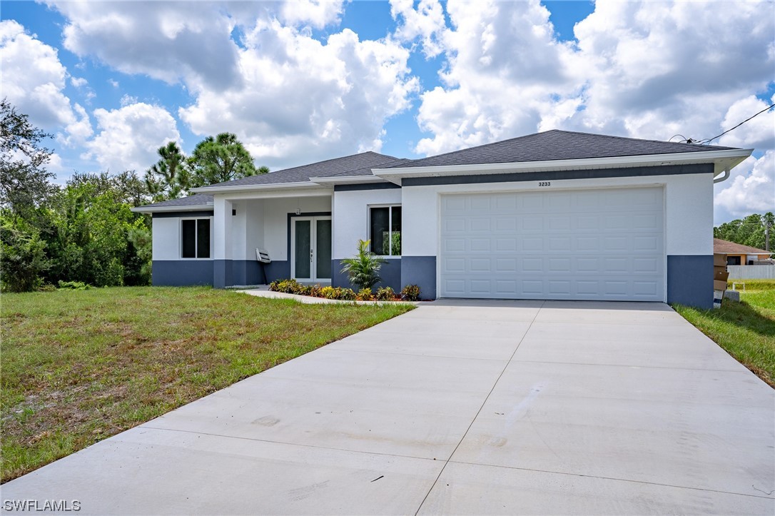 3233 Ruth Lane Lehigh Acres, FL 33976 - Photo 3 of 23 a view of backyard of house and car parked