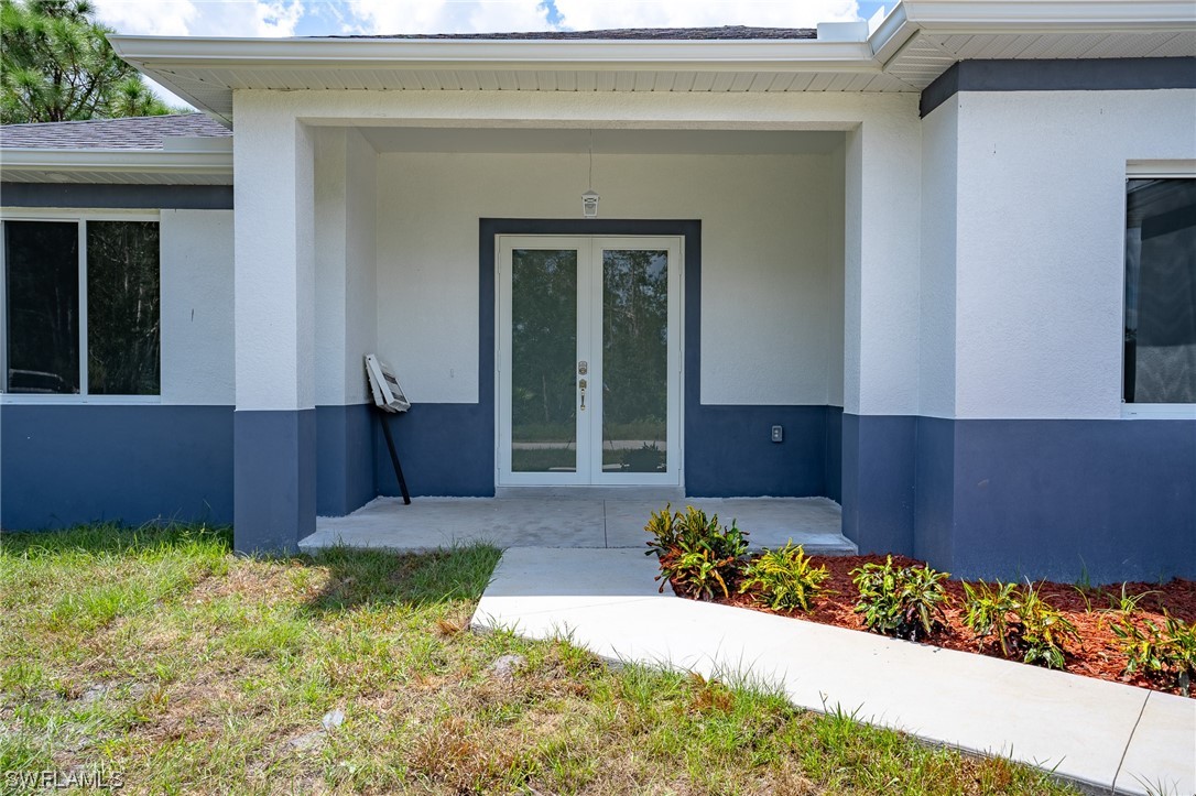 3233 Ruth Lane Lehigh Acres, FL 33976 - Photo 4 of 23 a house view with a garden space