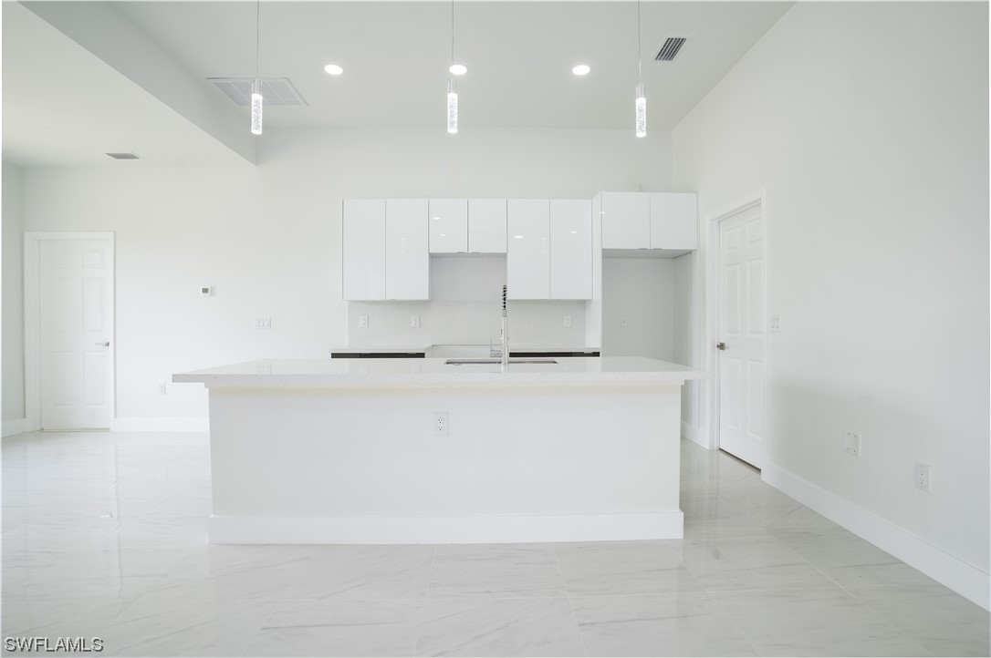 3233 Ruth Lane Lehigh Acres, FL 33976 - Photo 6 of 23 a view of kitchen cabinets and stainless steel appliances