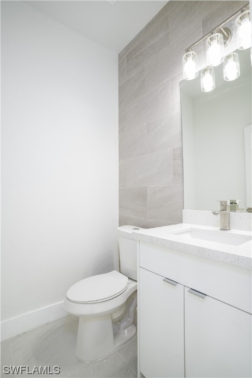 3233 Ruth Lane Lehigh Acres, FL 33976 - Photo 10 of 23 a bathroom with a toilet a sink and mirror