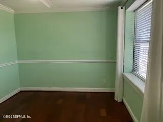 a room with a window and a wooden floor