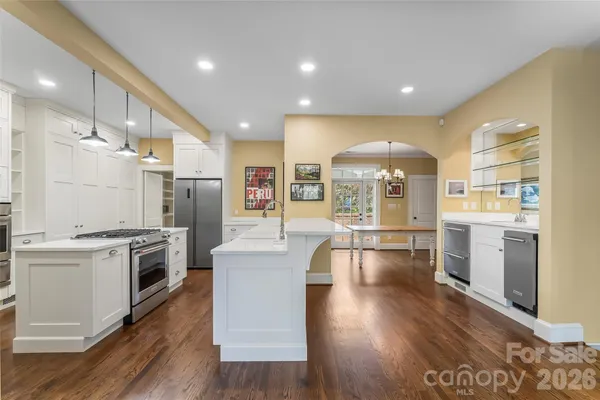 a view of a kitchen with a sink stove and refrigerator