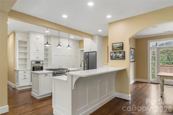 a kitchen with stainless steel appliances granite countertop a stove and a refrigerator