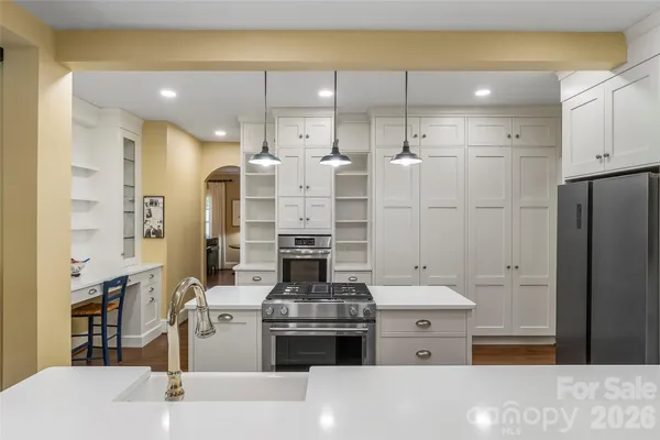 a kitchen with a stove and a refrigerator