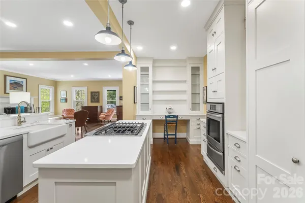 a kitchen with a sink a stove and chairs