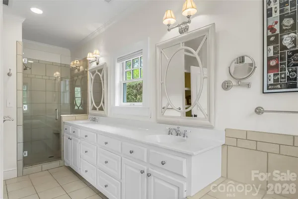 a bathroom with a double vanity sink mirror and