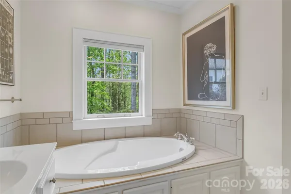 a bathroom with a bathtub and window