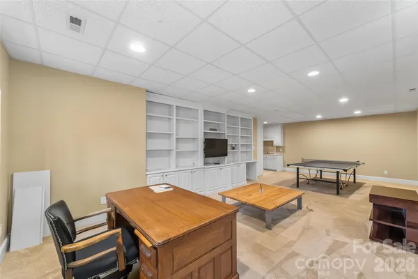 a room with furniture pool table and flat screen tv