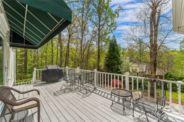 a view of a chairs and table on the wooden deck
