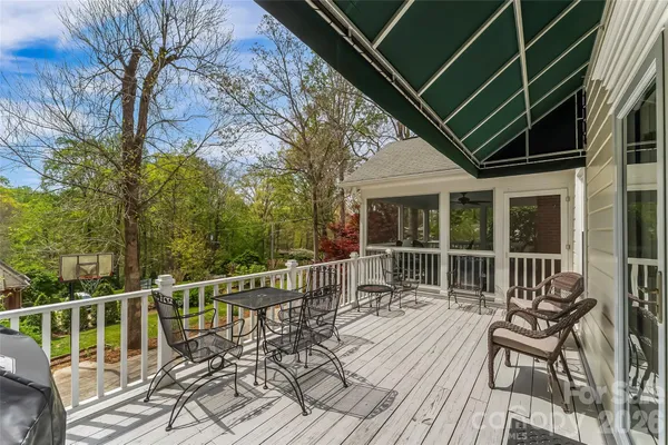 a view of balcony with wooden floor and outdoor seating