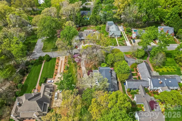 an aerial view of residential house with outdoor space and trees all around
