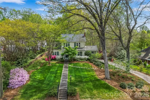 a view of a house with a yard and garden