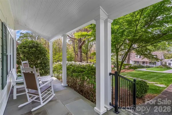 a view of a patio with a table chairs and a backyard