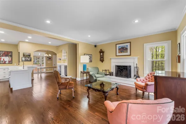 a living room with fireplace furniture and a wooden floor