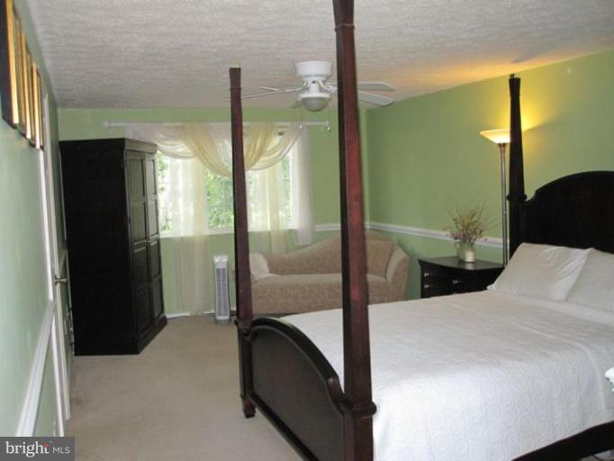 4438 Cub Run Road Chantilly, VA 20151 - Photo 6 of 16 a bedroom with a bed and a chandelier