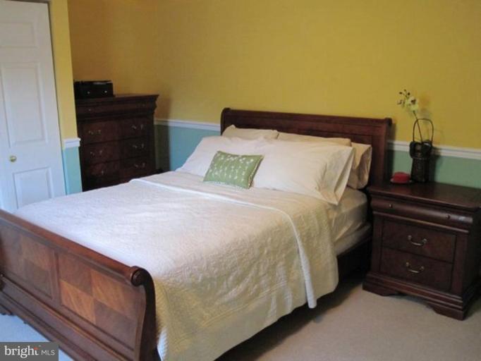 4438 Cub Run Road Chantilly, VA 20151 - Photo 7 of 16 a bed sitting in a bedroom and dresser