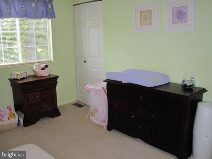 4438 Cub Run Road Chantilly, VA 20151 - Photo 8 of 16 a room with a dresser and a window