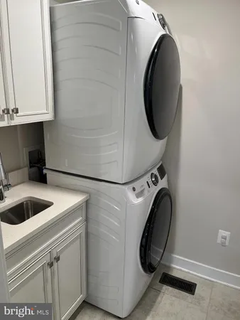 a utility room with sink dryer and washer
