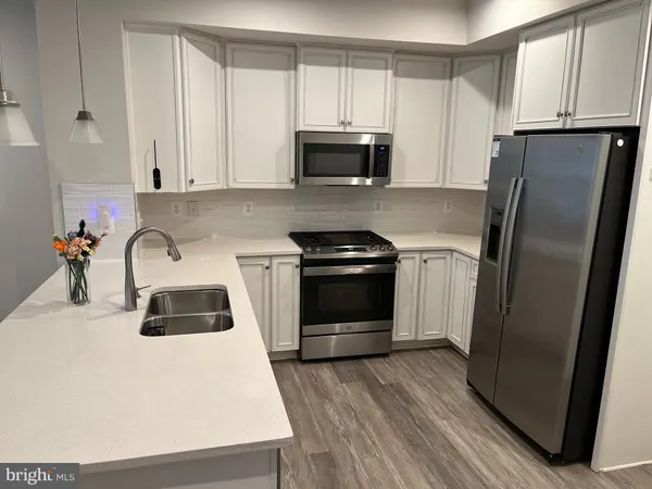 a kitchen with a refrigerator sink and microwave