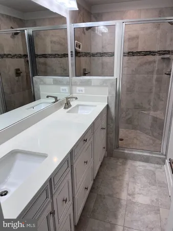 a bathroom with a double vanity sink and a mirror