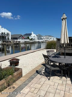 8 Diane Road Manahawkin, NJ 08050 - Photo 9 of 11 a view of a lake with a table and chairs