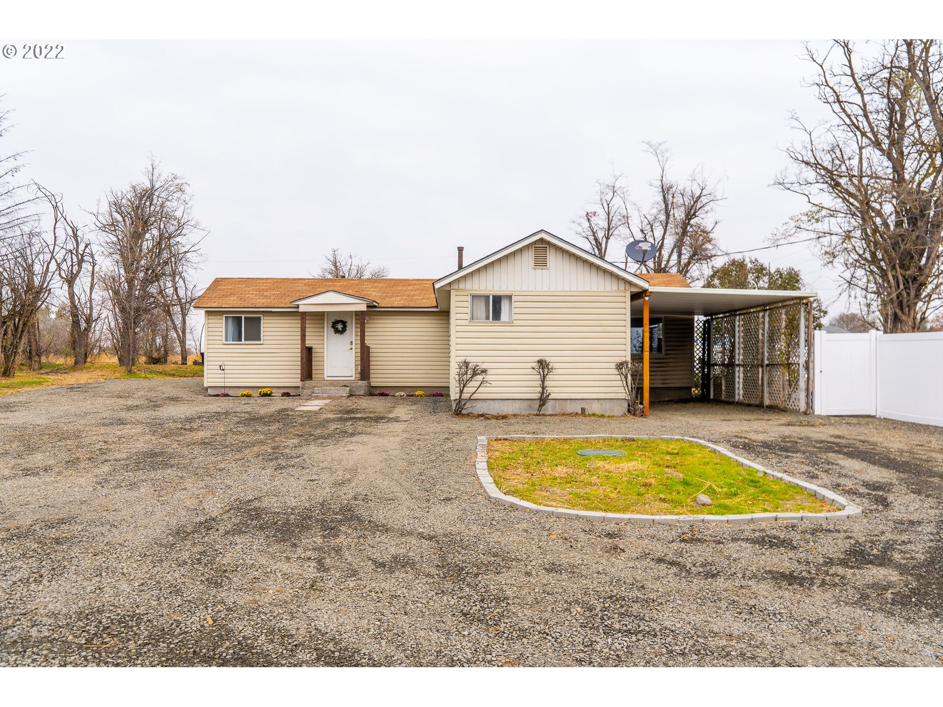 80632 Craig Road Hermiston, OR 97838 - Photo 1 of 25 a view of a white house with a swimming pool and a yard