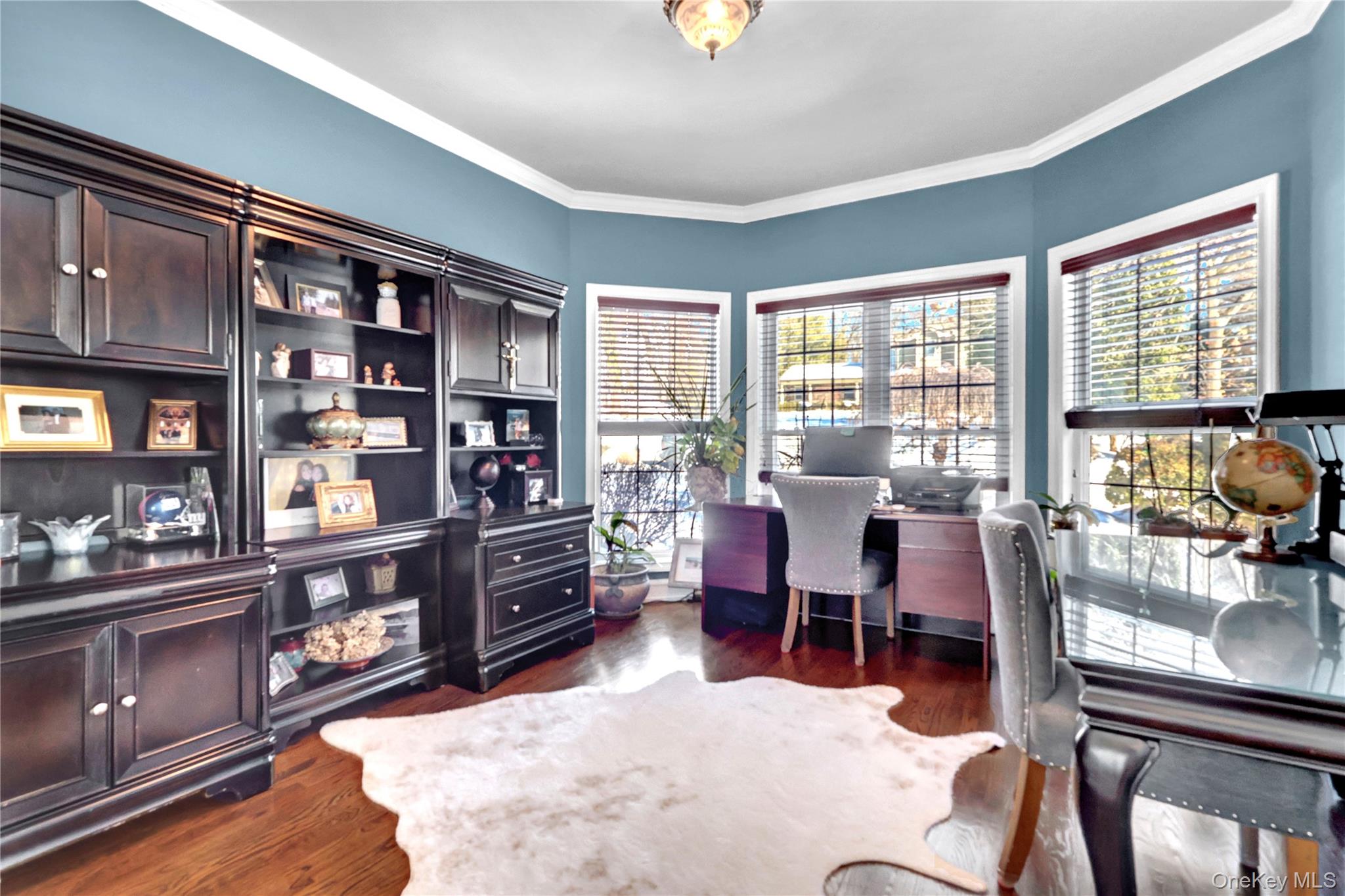 5 Frost Valley Road Mount Sinai, NY 11766 - Photo 13 of 49 a living room with furniture a bookshelf and a window