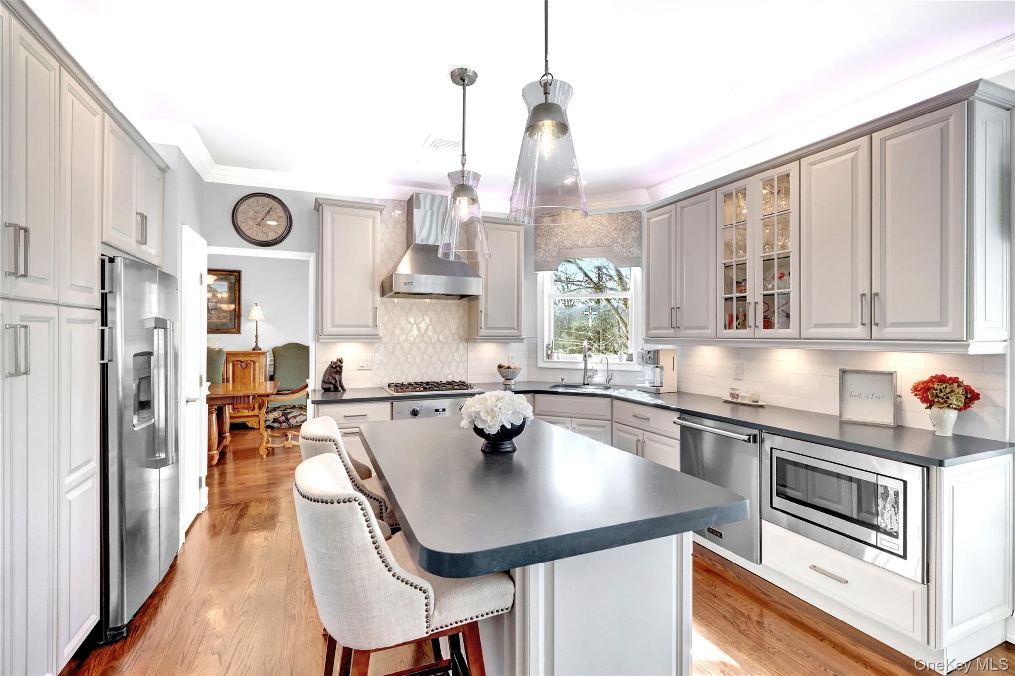 5 Frost Valley Road Mount Sinai, NY 11766 - Photo 14 of 49 a kitchen with stainless steel appliances a sink a stove a table and chairs