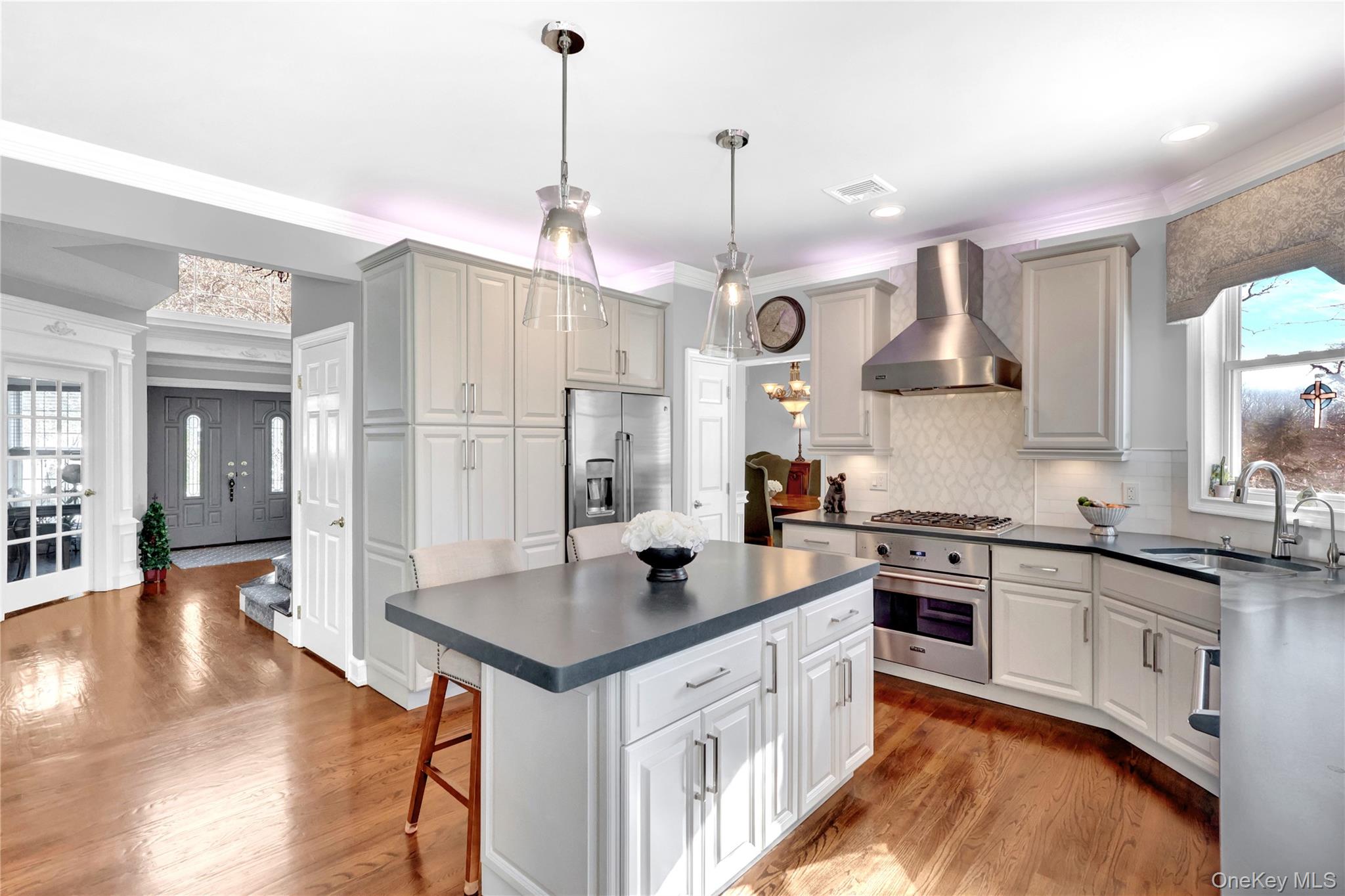 5 Frost Valley Road Mount Sinai, NY 11766 - Photo 15 of 49 a kitchen with stainless steel appliances granite countertop a sink a stove a refrigerator and island with wooden floor