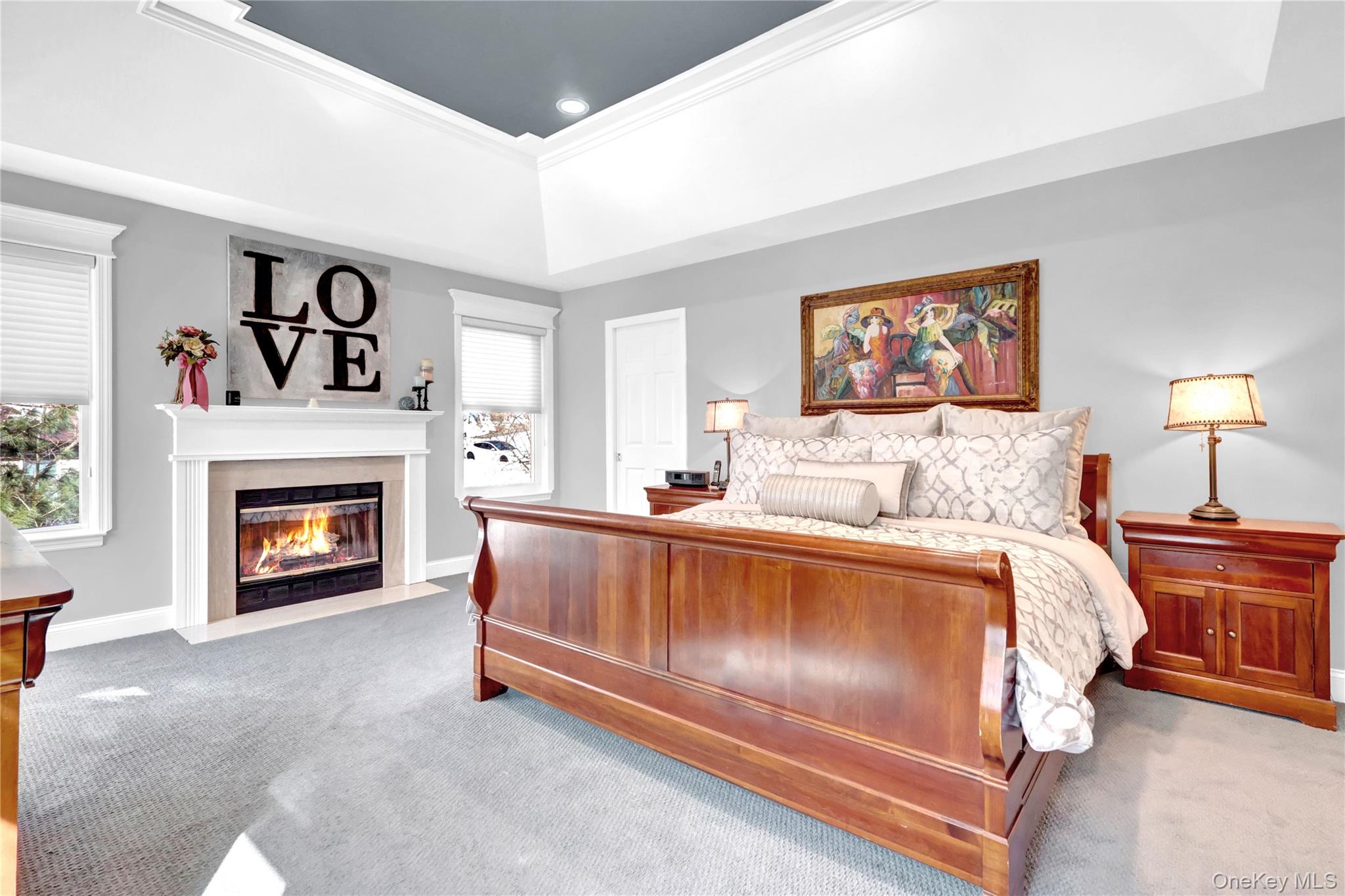 5 Frost Valley Road Mount Sinai, NY 11766 - Photo 24 of 49 a spacious bedroom with a bed and a fireplace