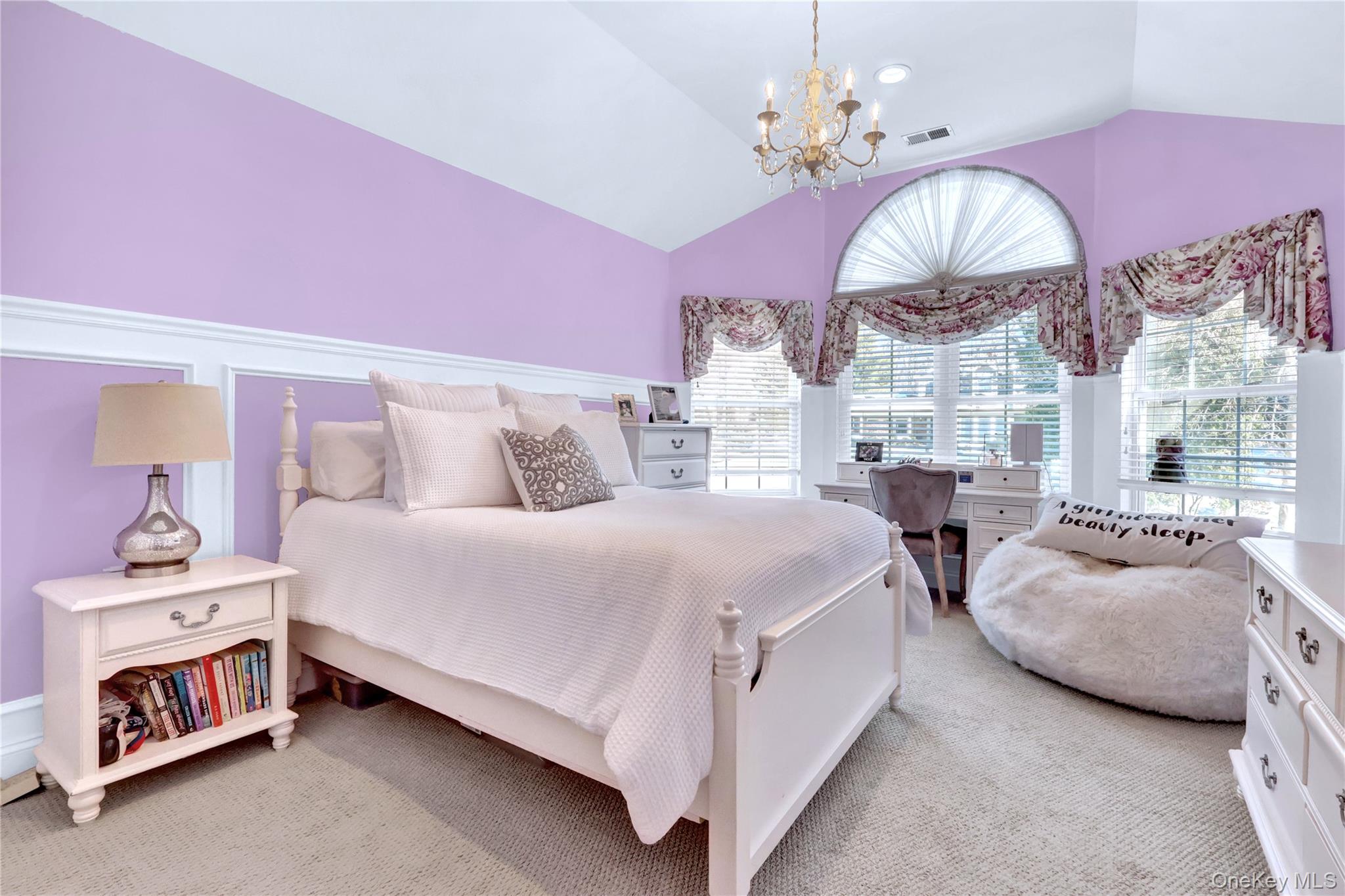 5 Frost Valley Road Mount Sinai, NY 11766 - Photo 27 of 49 a spacious bedroom with bed and a chandelier