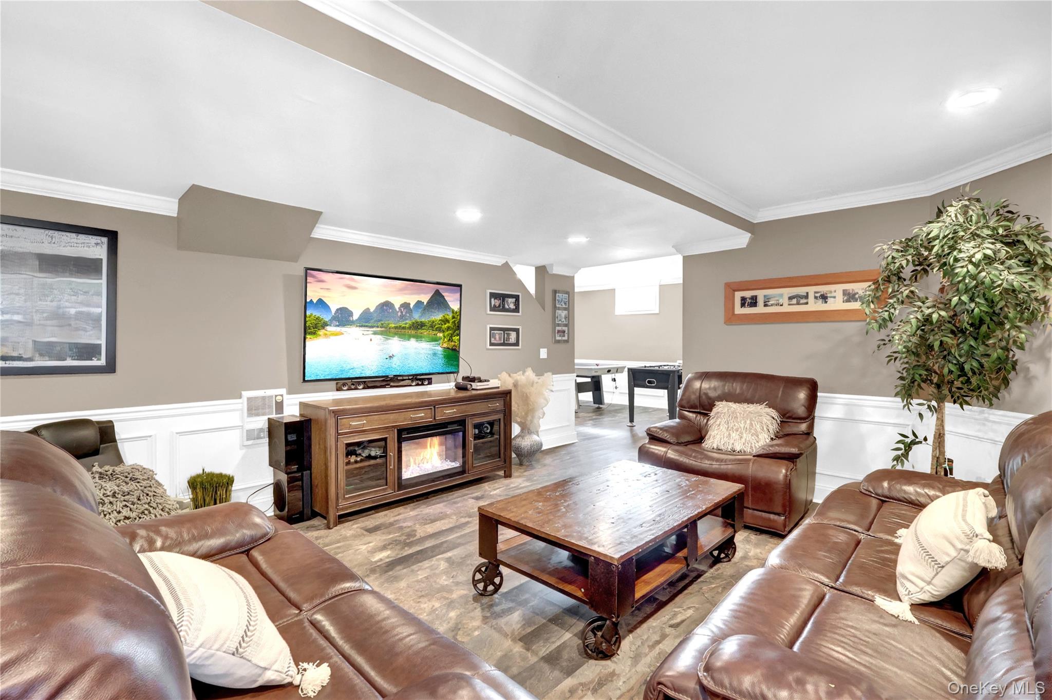 5 Frost Valley Road Mount Sinai, NY 11766 - Photo 32 of 49 a living room with furniture and a flat screen tv