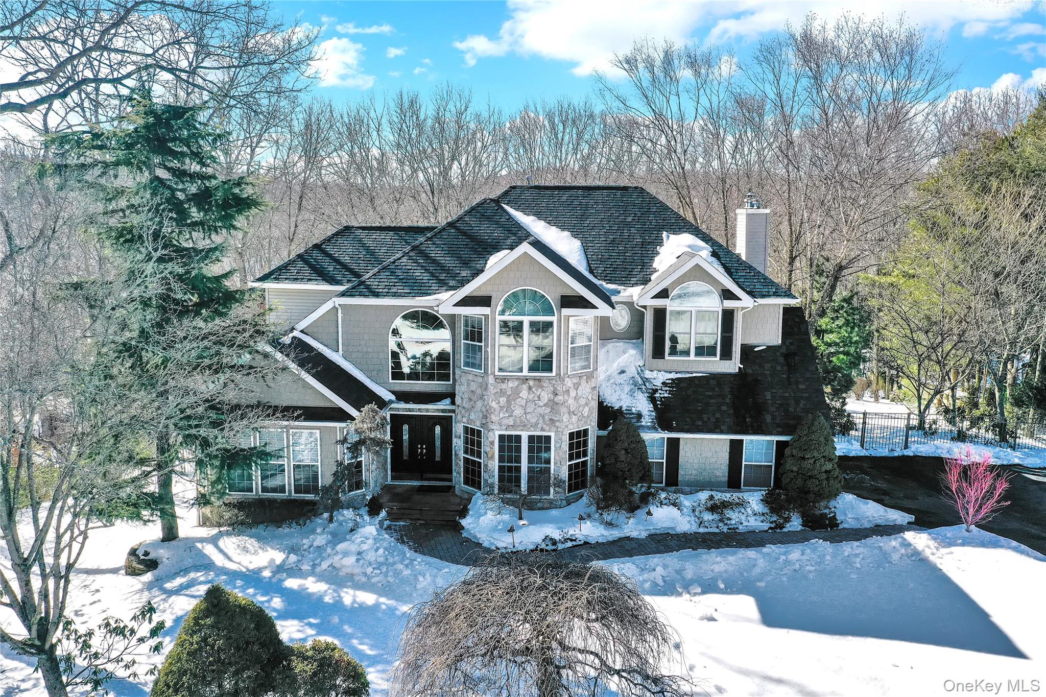 5 Frost Valley Road Mount Sinai, NY 11766 - Photo 4 of 49 a front view of a house with a yard garage and outdoor seating