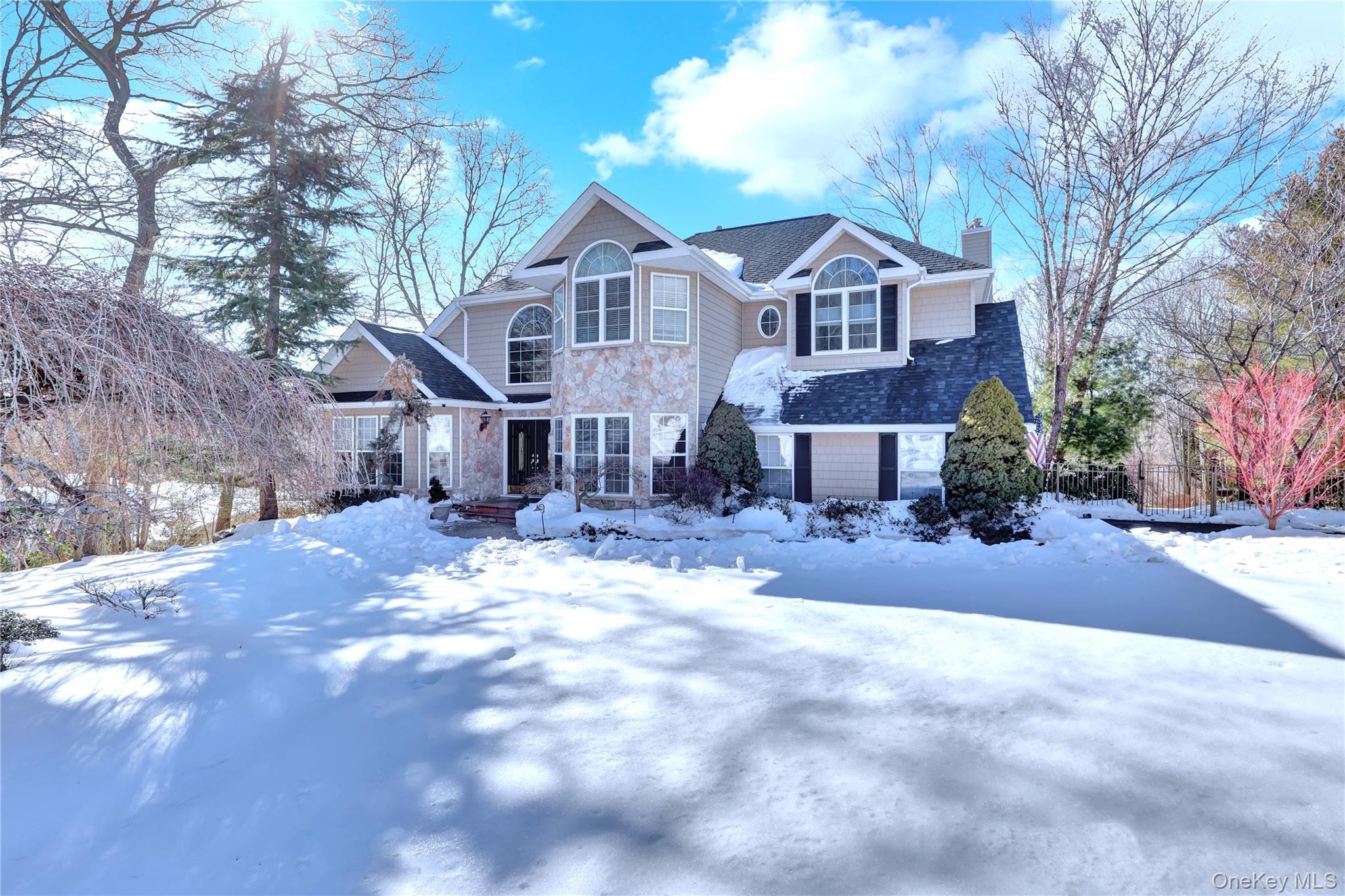 5 Frost Valley Road Mount Sinai, NY 11766 - Photo 5 of 49 a front view of a house with a yard covered in snow