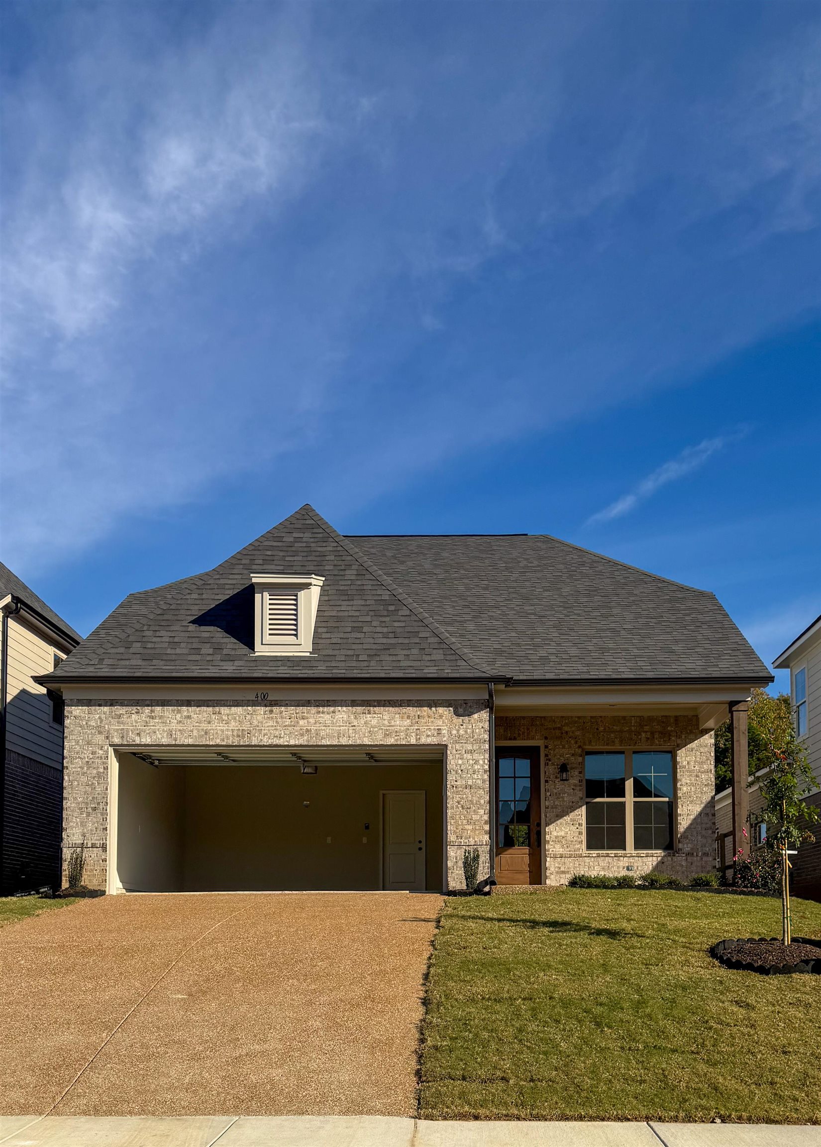 400 Maple Street Oakland, TN 38060 - Photo 1 of 14 View of front of home featuring a garage and a front lawn