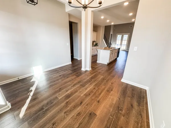 a view of a livingroom with wooden floor and a ceiling fan