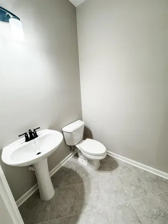 a white toilet sitting next to a bathroom sink