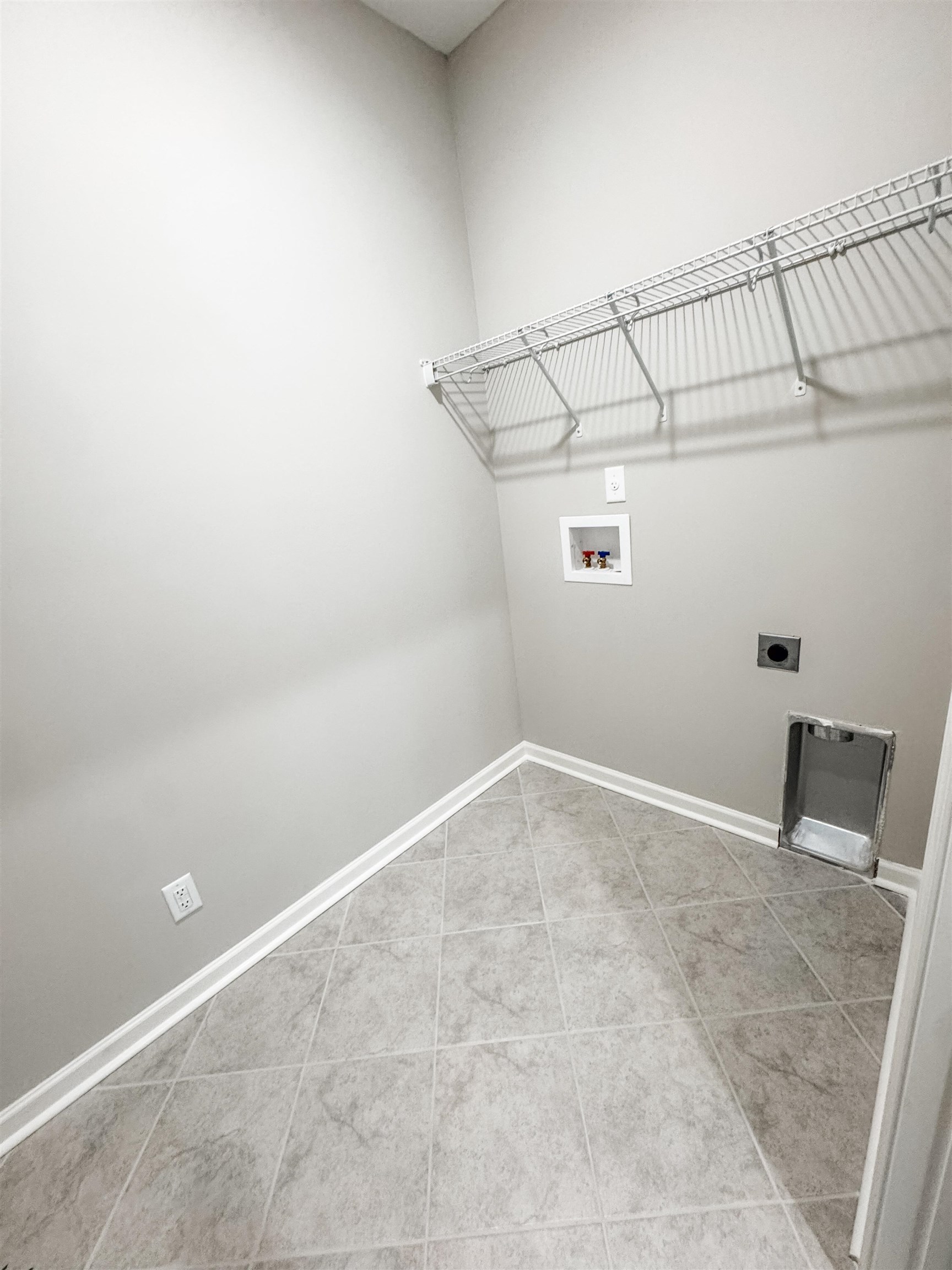 400 Maple Street Oakland, TN 38060 - Photo 8 of 14 Laundry room with hookup for a washing machine, tile patterned floors, and electric dryer hookup