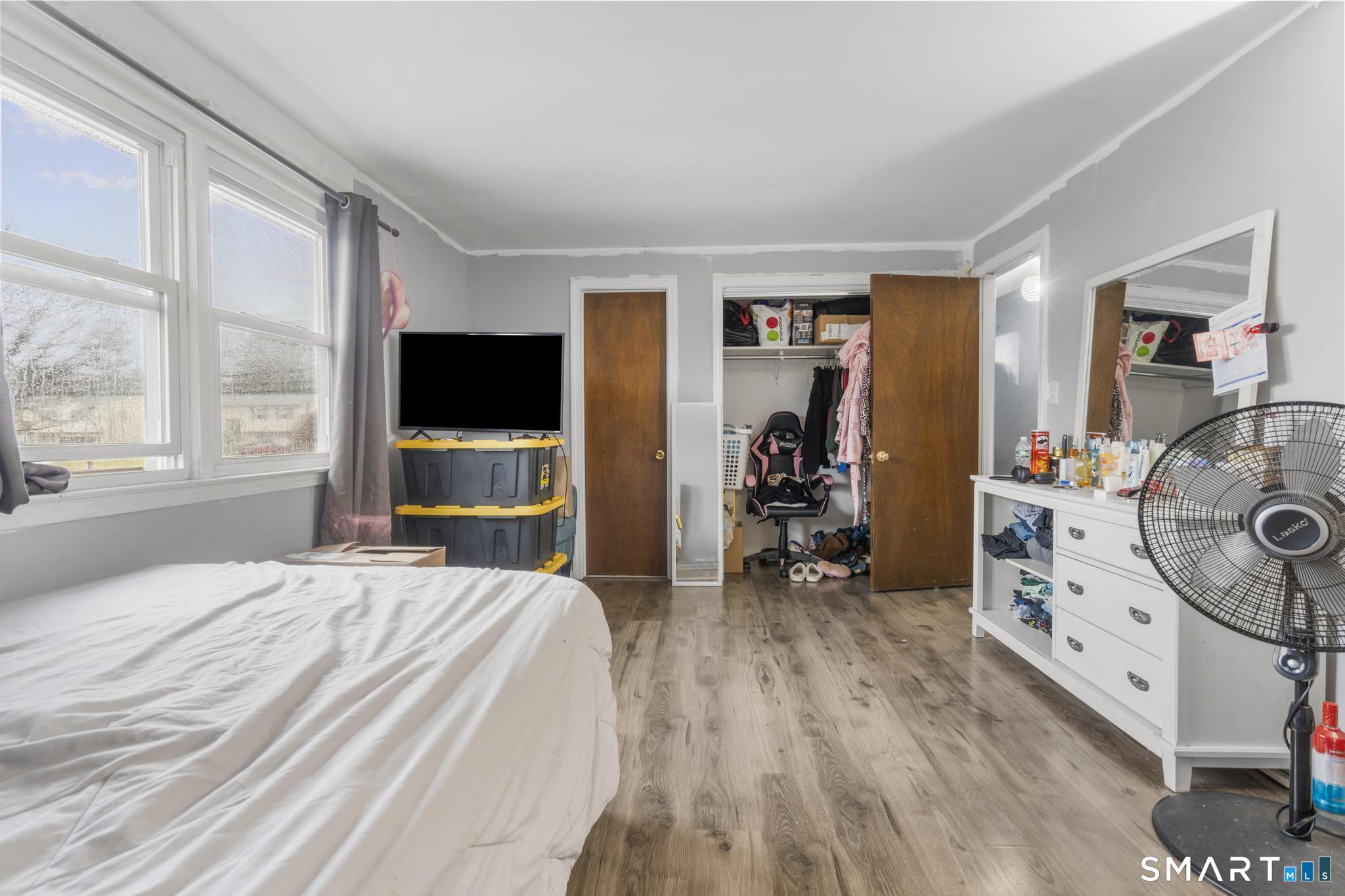 7 Pettit Drive Meriden, CT 06451 - Photo 23 of 35 a bedroom with a bed and a flat tv screen on the dresser