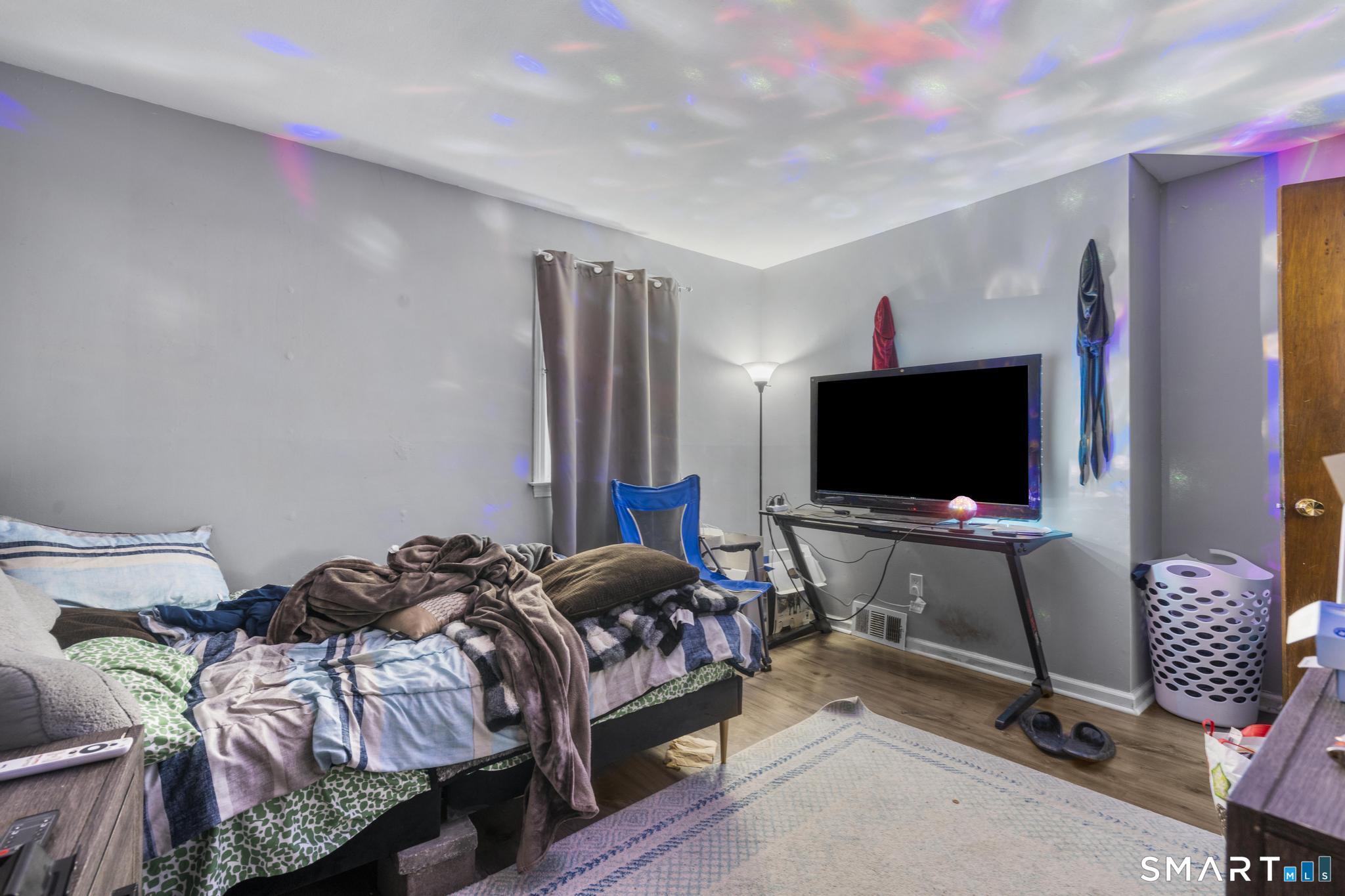 7 Pettit Drive Meriden, CT 06451 - Photo 24 of 35 a bedroom with a bed and a flat screen tv