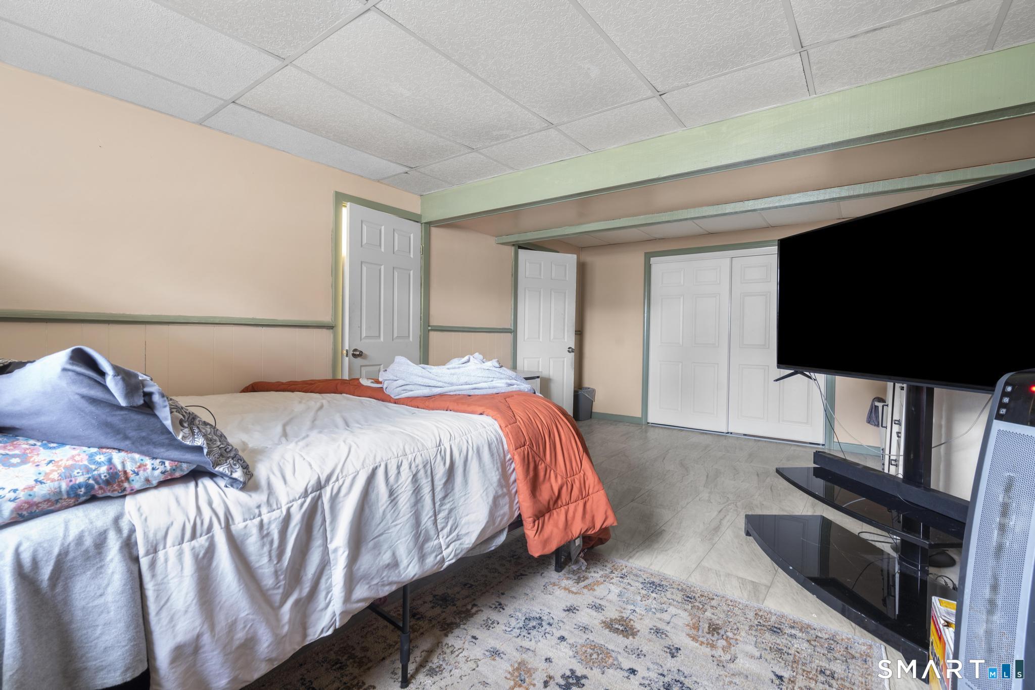 7 Pettit Drive Meriden, CT 06451 - Photo 26 of 35 a bedroom with a bed and a flat screen tv