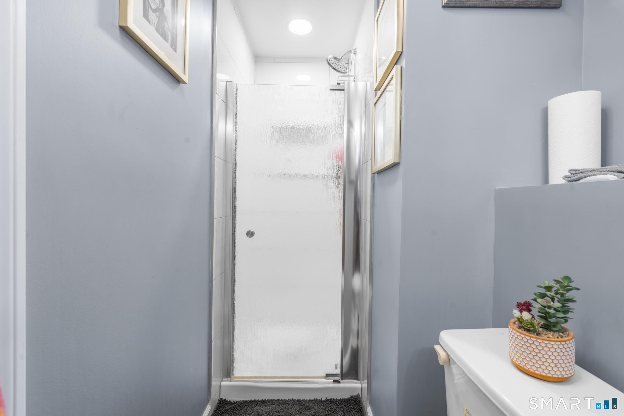 7 Pettit Drive Meriden, CT 06451 - Photo 32 of 35 a bathroom with a sink a mirror and a window