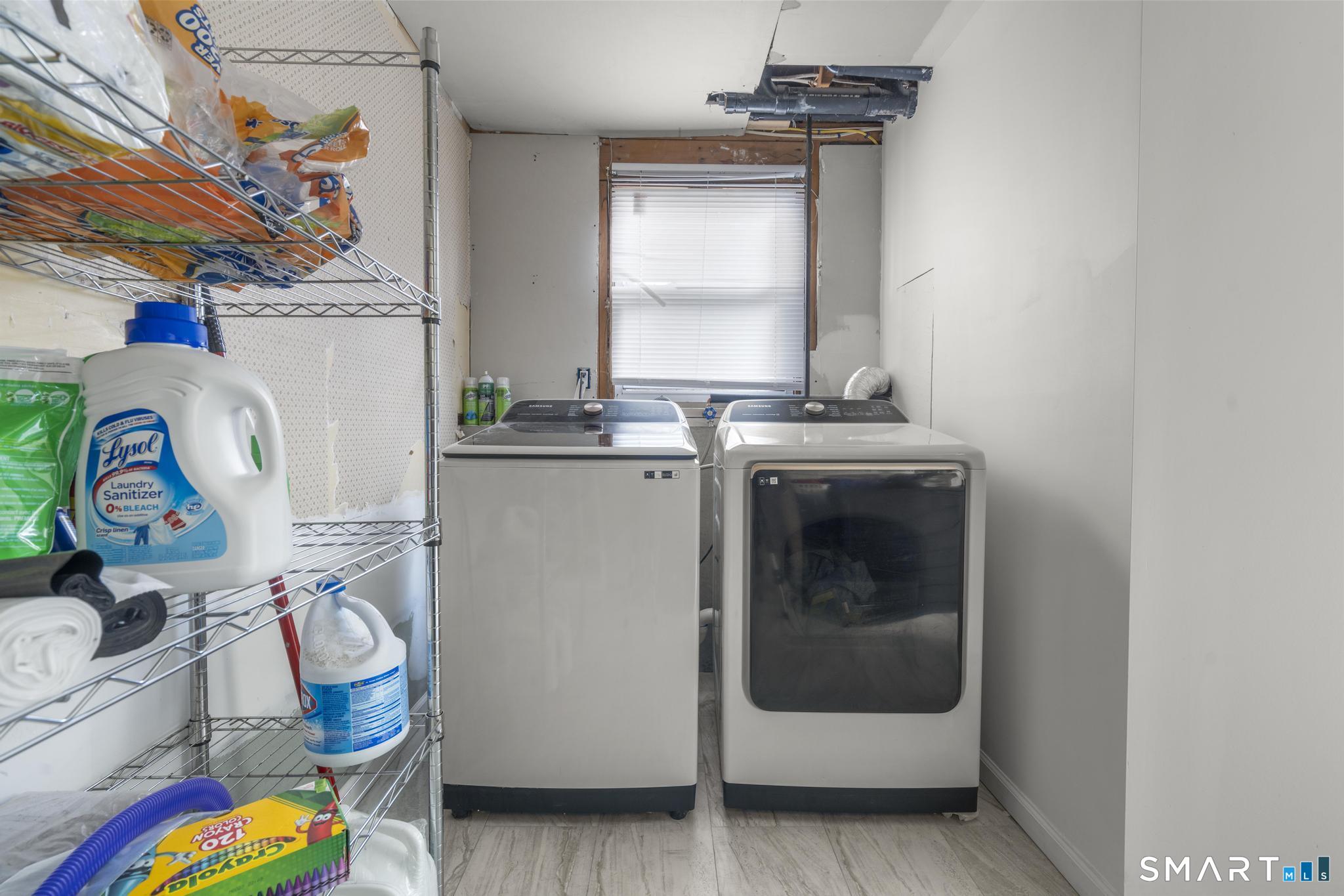 7 Pettit Drive Meriden, CT 06451 - Photo 33 of 35 a utility room with fridge and wooden floor