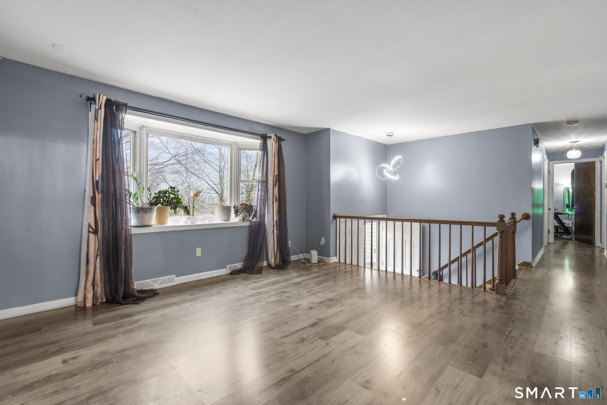 7 Pettit Drive Meriden, CT 06451 - Photo 10 of 35 an empty room with wooden floor and windows