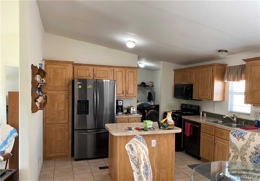13411 South Water Reed Way Topock, AZ 86436 - Photo 6 of 18 a kitchen with a refrigerator a stove top oven a sink and dishwasher