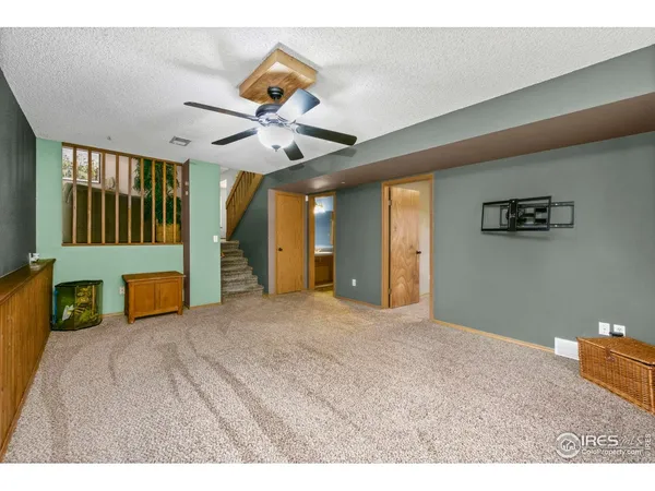 a view of a livingroom with a ceiling fan and window